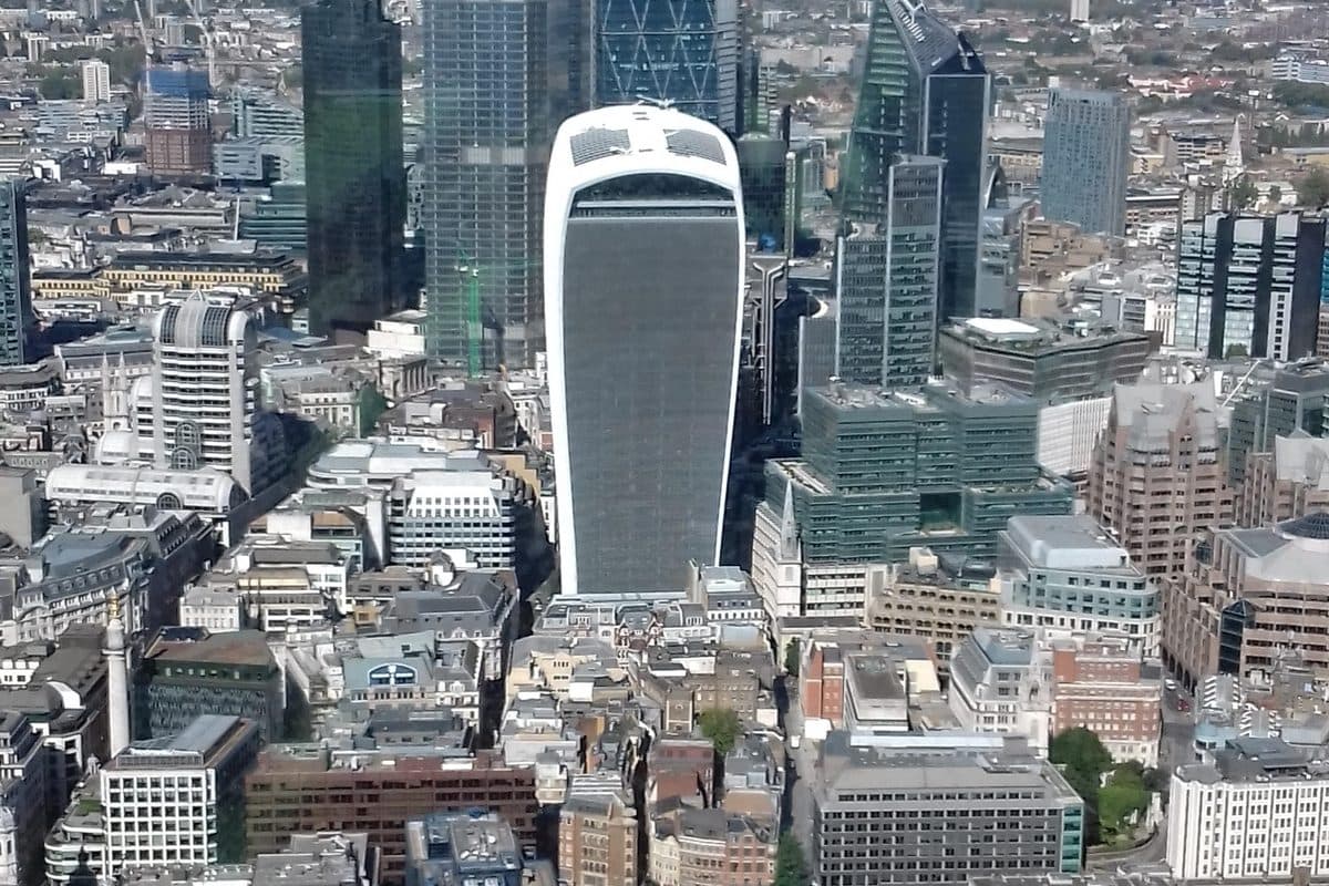 The City of London from above, the tower cluster set against the low roofs around it and the river beyond.