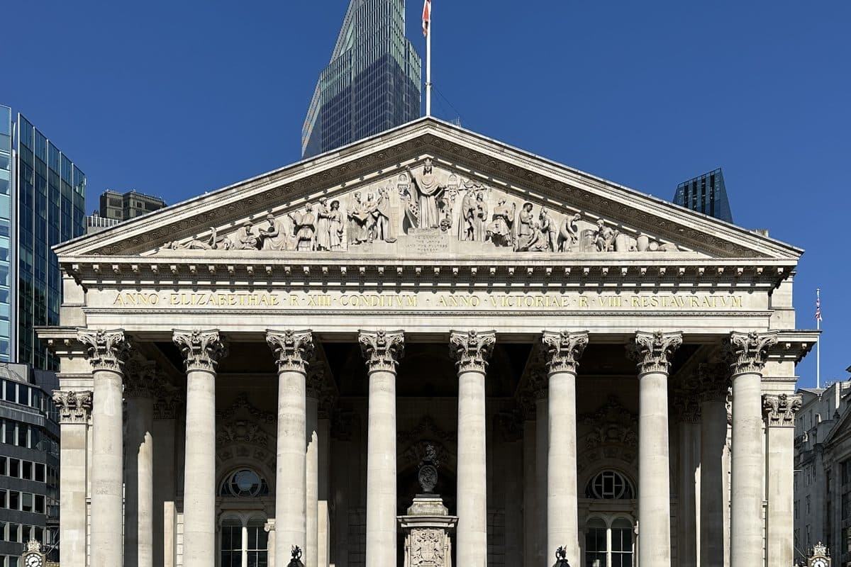 The portico of the Royal Exchange at Bank, with a modern tower rising behind it.